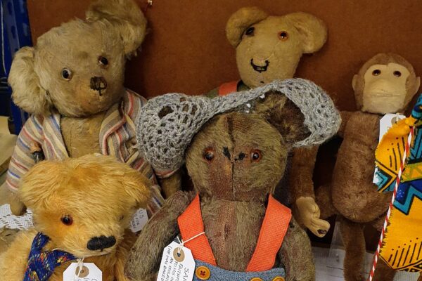 A group of traditional teddy bears and a monkey