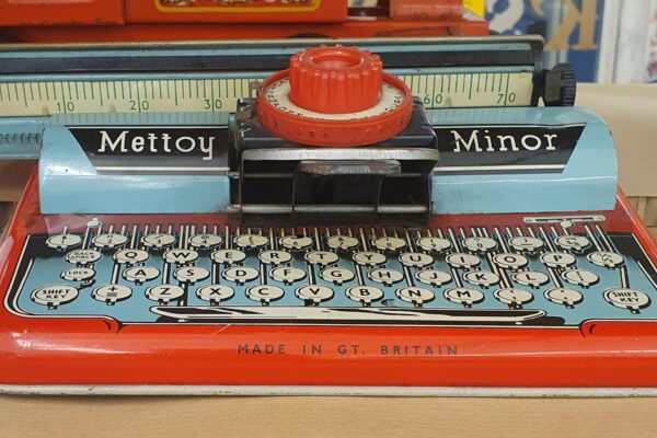 Red and blue tin toy typewriter made by Mettoy