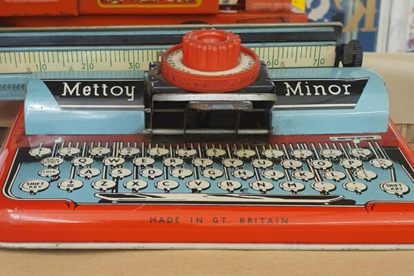 Red and blue tin toy typewriter made by Mettoy
