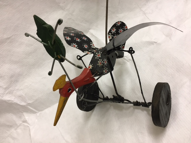 Toy bird chasing an elusive bug. Simple wire linkages create a range of movements as the toy is pushed along. European, 20th century.