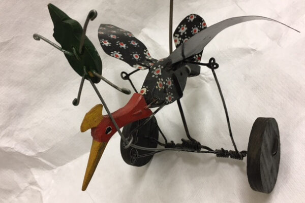 Toy bird chasing an elusive bug. Simple wire linkages create a range of movements as the toy is pushed along. European, 20th century.