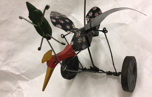 Toy bird chasing an elusive bug. Simple wire linkages create a range of movements as the toy is pushed along. European, 20th century.