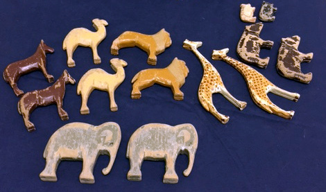 7 pairs of carved wooden toy animals, including elephants, giraffes and lions.